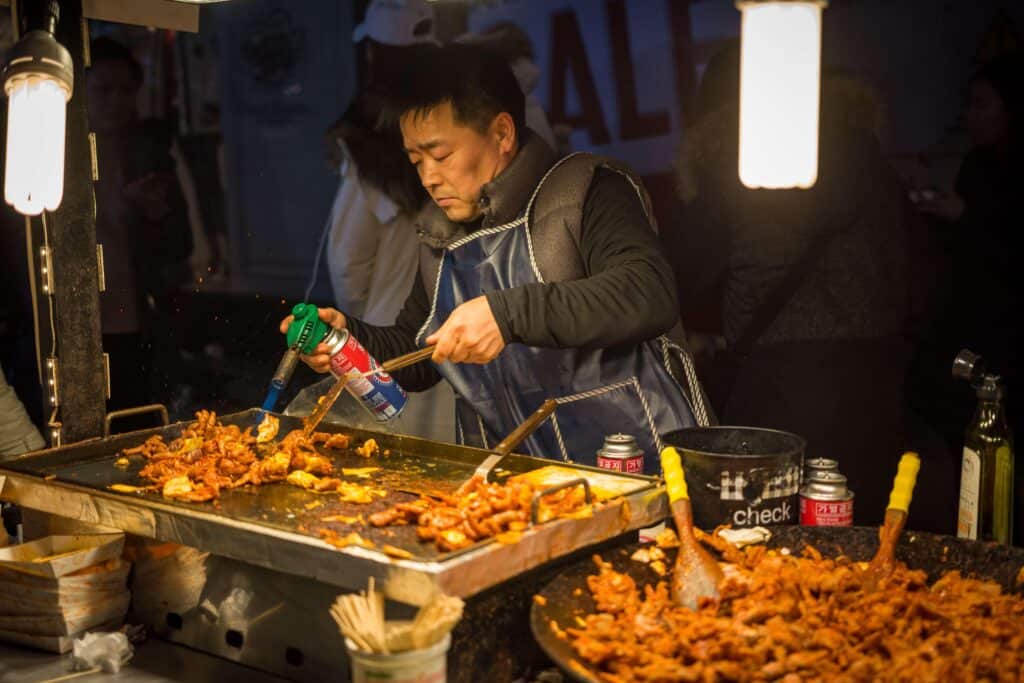 myeongdong night market food guide 2026 korean street food vendor cooking dakgalbi