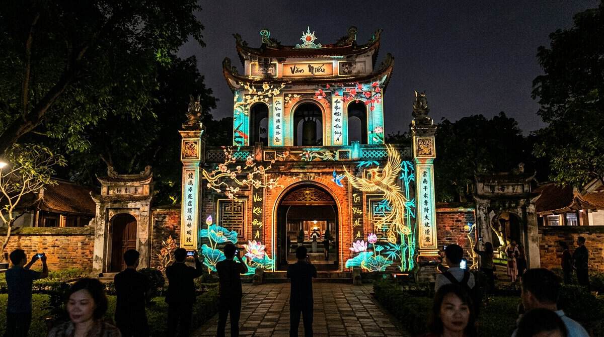A vibrant 3D projection mapping display showing glowing traditional Vietnamese